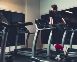 rear-view-woman-running-treadmill